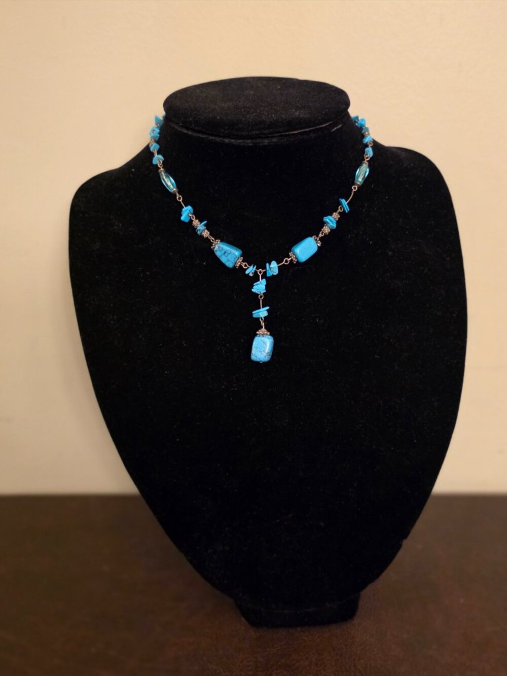 Necklace features blue-turquoise stone chips with lobster closure